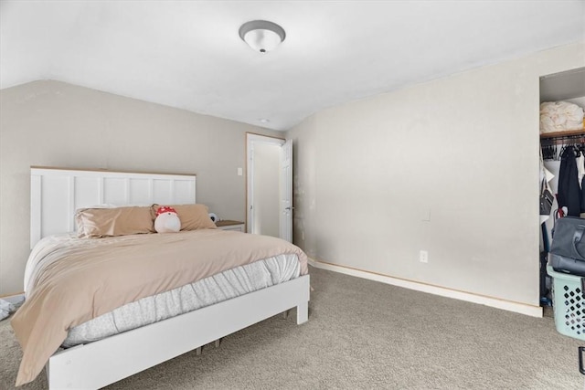 bedroom with vaulted ceiling and carpet floors