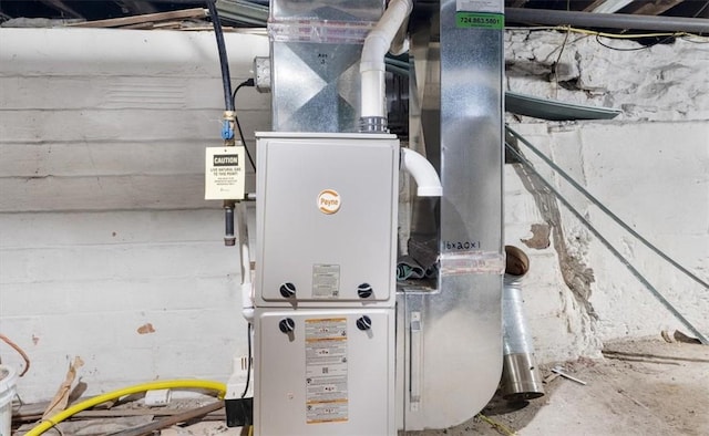 utility room featuring heating unit