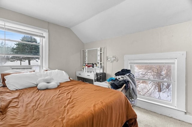 carpeted bedroom with vaulted ceiling