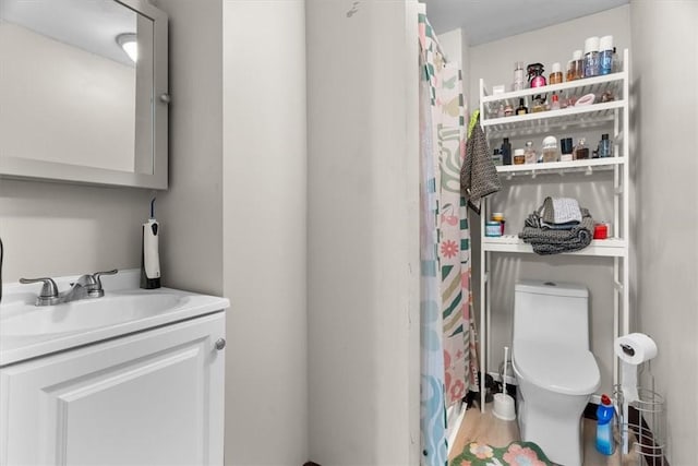 bathroom featuring vanity and toilet