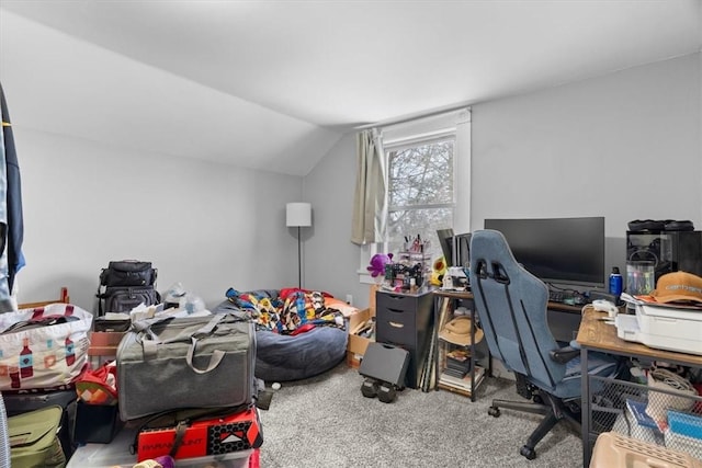 carpeted home office featuring lofted ceiling