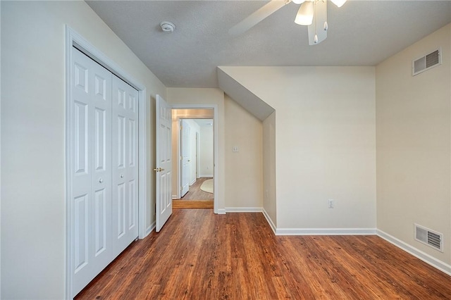 hall with dark hardwood / wood-style floors and a textured ceiling