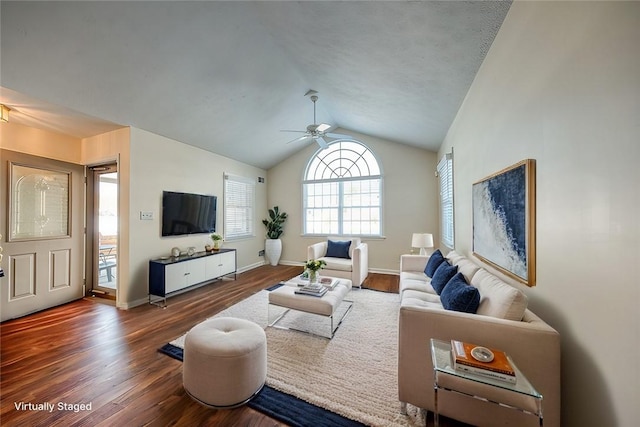 living room featuring lofted ceiling, dark wood-type flooring, and ceiling fan