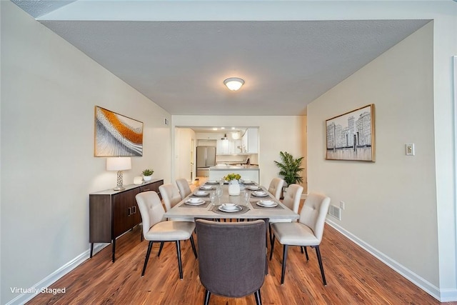 dining space featuring wood-type flooring