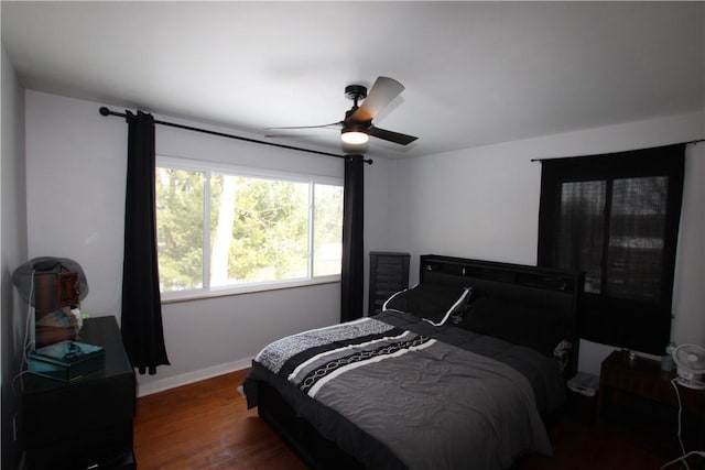 bedroom with dark wood-type flooring and ceiling fan