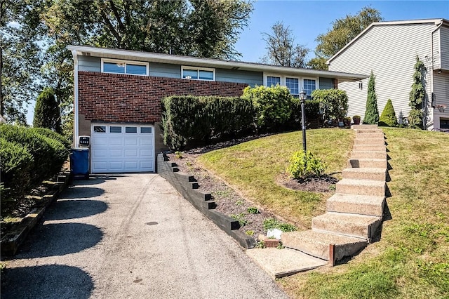 view of front of home featuring a garage and a front yard