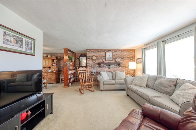 carpeted living room with brick wall