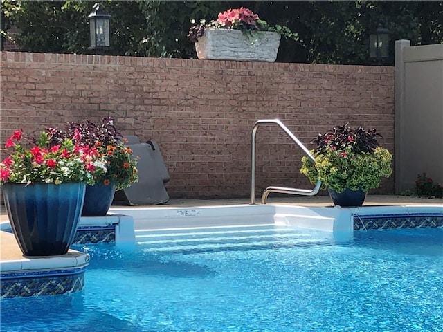 view of pool with pool water feature