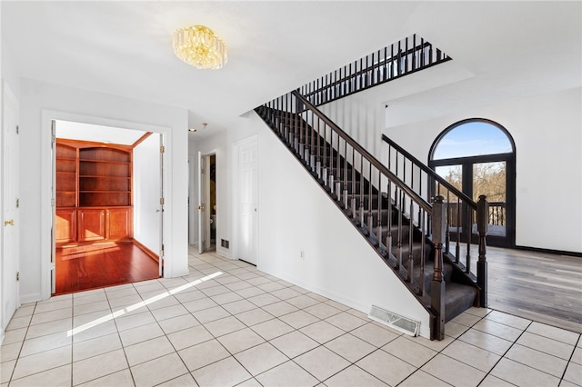 stairs with tile patterned floors