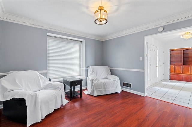 living area featuring crown molding and wood-type flooring