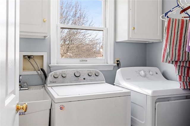 laundry room with cabinets, washer and clothes dryer, and sink