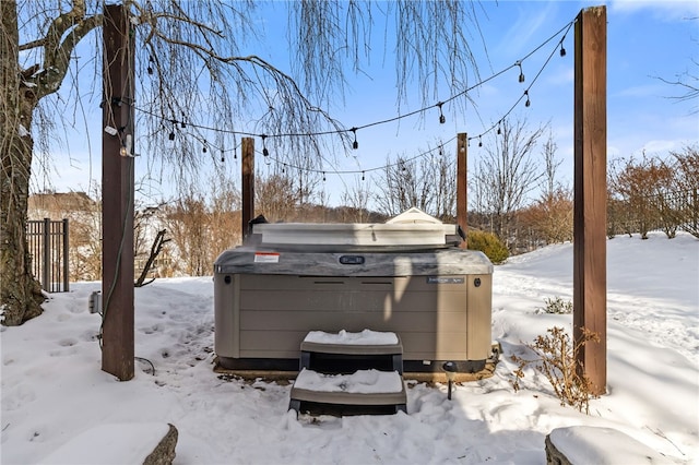 snowy yard with a hot tub