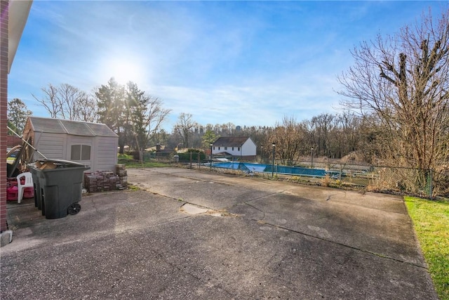 exterior space featuring a storage shed and a pool