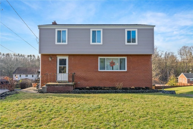 rear view of property with a lawn