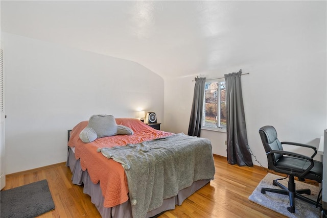 bedroom featuring vaulted ceiling and hardwood / wood-style floors