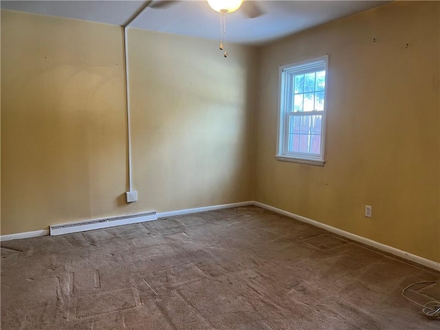 carpeted spare room featuring baseboard heating and ceiling fan