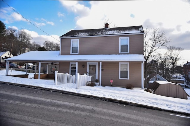 view of front of home featuring a storage shed and a porch