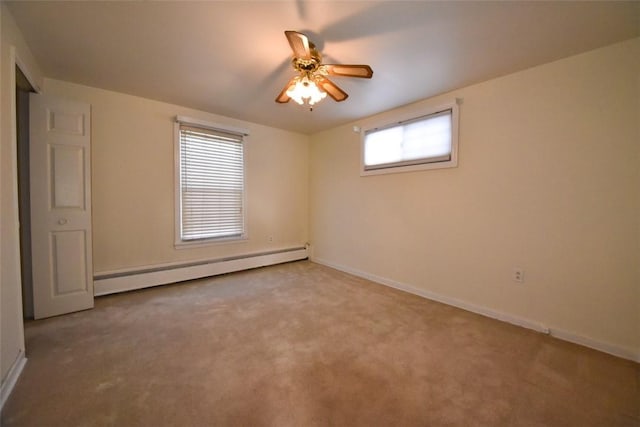 spare room with a baseboard radiator, carpet flooring, and ceiling fan