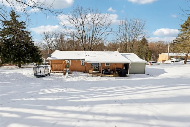 view of snow covered back of property