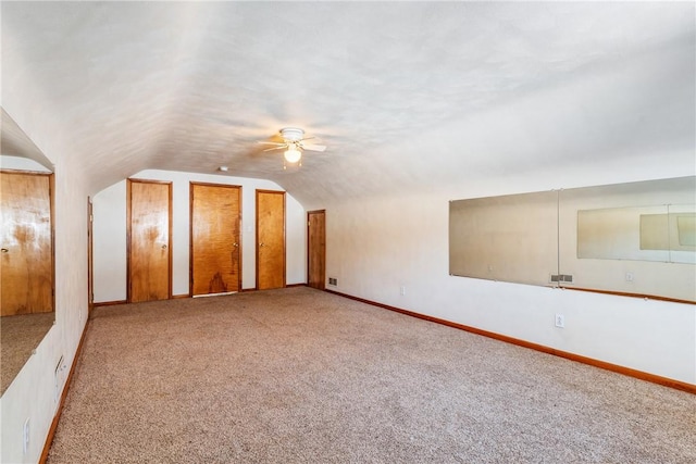 additional living space with lofted ceiling, light carpet, and ceiling fan