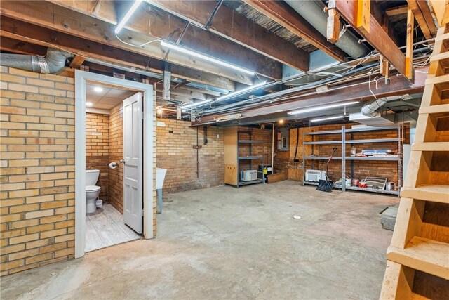 basement featuring brick wall