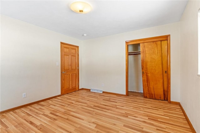 unfurnished bedroom with light hardwood / wood-style floors and a closet