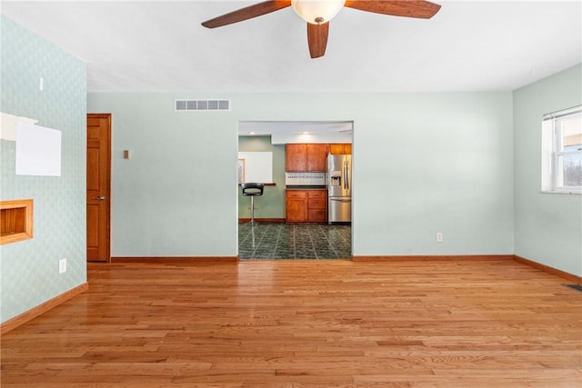 spare room featuring ceiling fan and light hardwood / wood-style floors