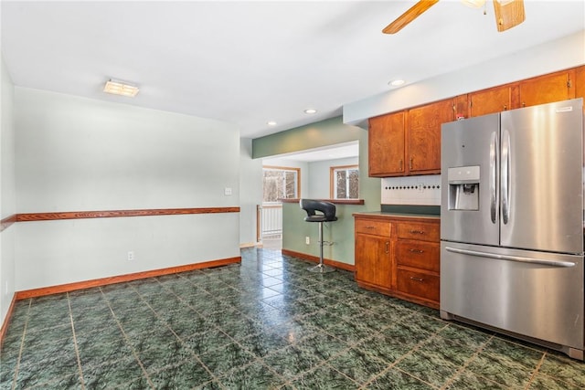 kitchen with ceiling fan and stainless steel fridge with ice dispenser