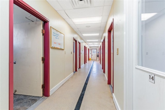 corridor featuring a paneled ceiling