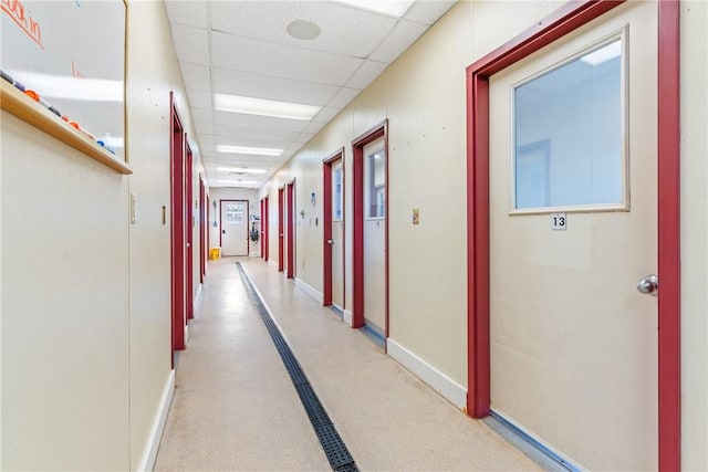 corridor featuring a paneled ceiling