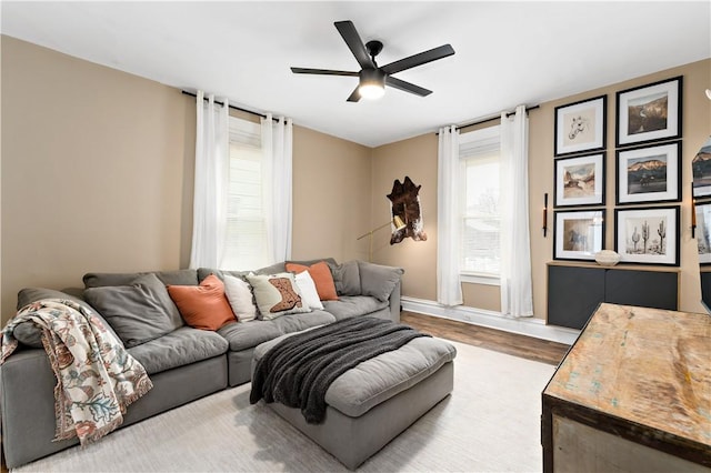 living room featuring ceiling fan and light hardwood / wood-style floors