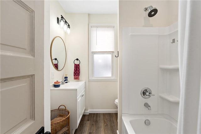 full bathroom featuring hardwood / wood-style floors, vanity, a wealth of natural light, and washtub / shower combination