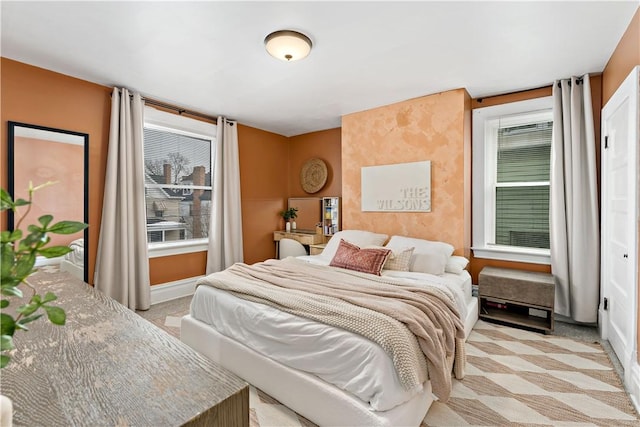 carpeted bedroom featuring multiple windows