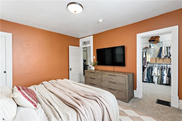 bedroom featuring light colored carpet and a closet