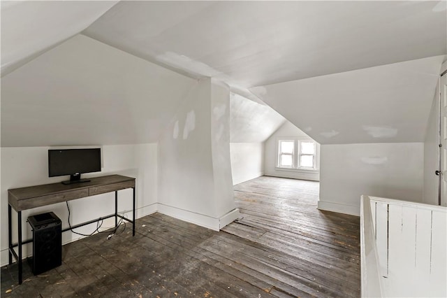 additional living space featuring dark hardwood / wood-style flooring and vaulted ceiling