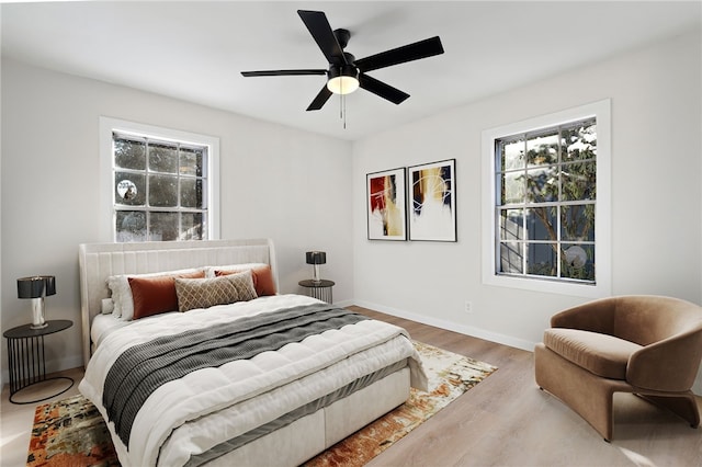 bedroom with wood-type flooring and ceiling fan