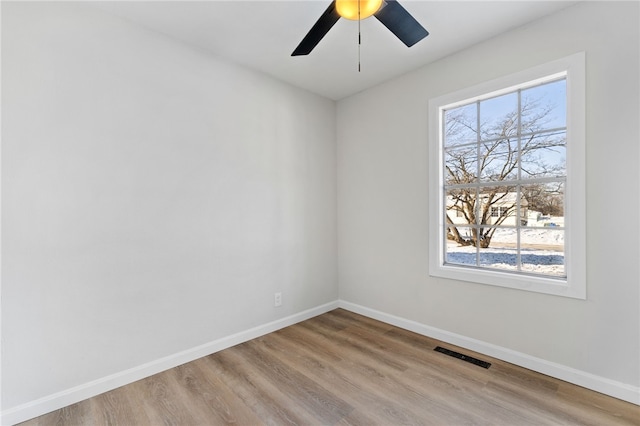 empty room featuring ceiling fan and light hardwood / wood-style flooring