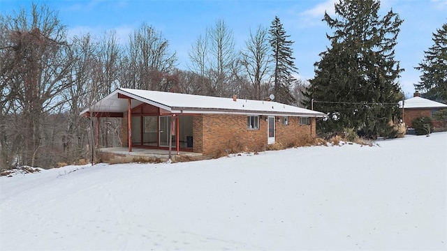 view of snowy exterior featuring covered porch