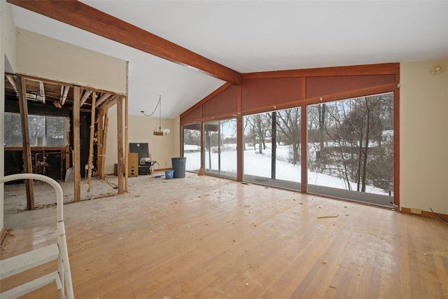 interior space featuring lofted ceiling with beams and plenty of natural light