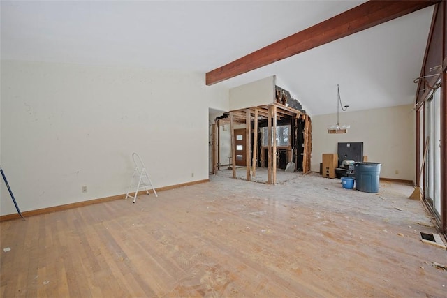 unfurnished living room with lofted ceiling with beams