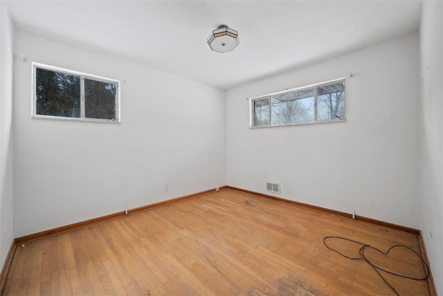 spare room with light hardwood / wood-style flooring