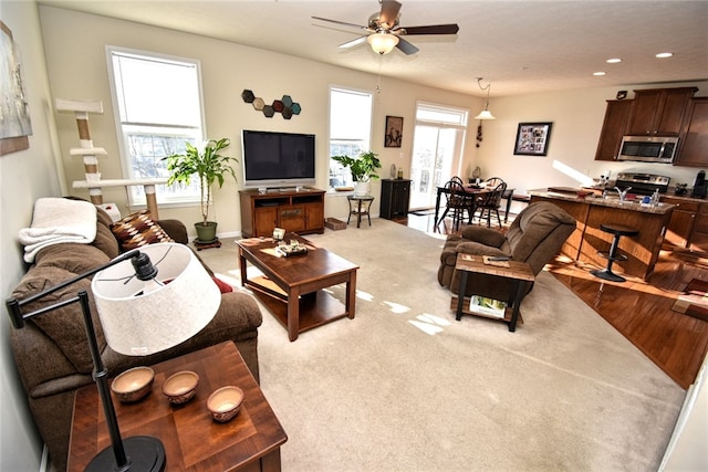 living room with carpet and ceiling fan