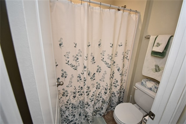 bathroom with tile patterned floors and toilet