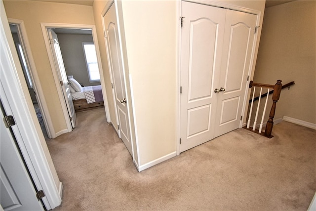 hallway with light colored carpet