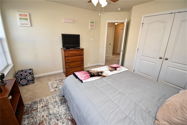 bedroom with light carpet, a closet, and ceiling fan