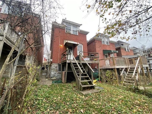 back of property featuring a wooden deck