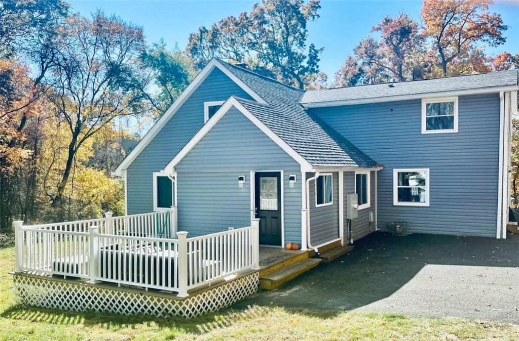 rear view of house with a wooden deck