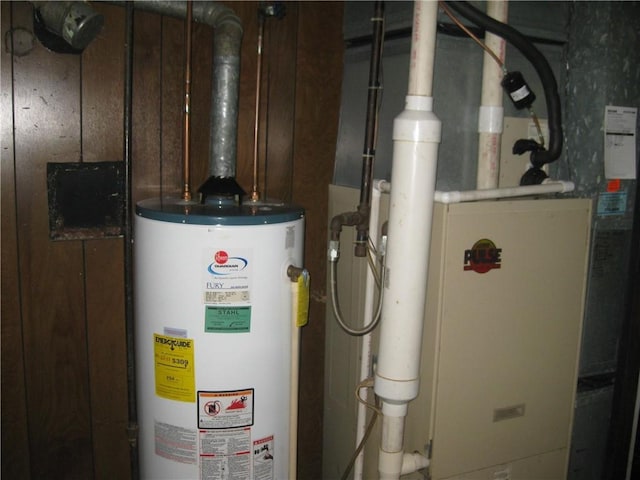 utility room with heating unit and gas water heater