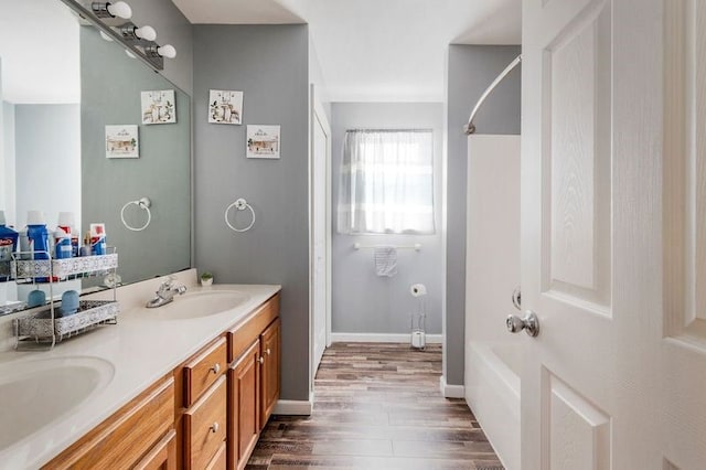 bathroom with vanity, hardwood / wood-style flooring, and shower / bath combination