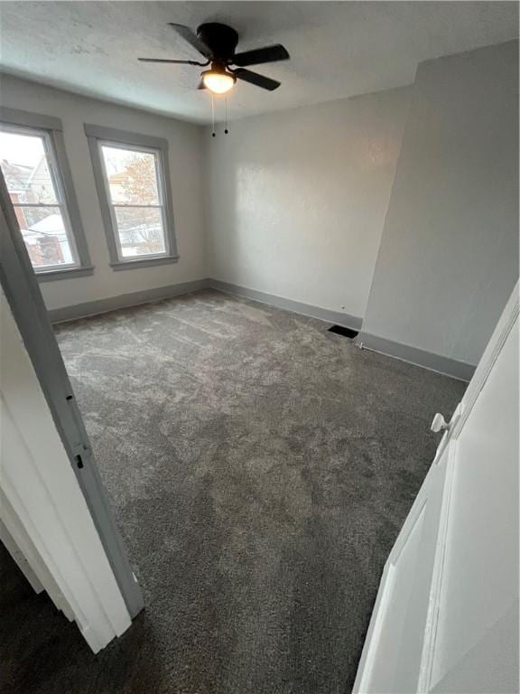 unfurnished room featuring carpet and ceiling fan